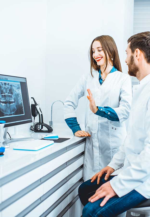 Zahnmedizinische Fachkräfte, die in der Zahnarztpraxis mit einem Computer arbeiten