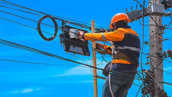 Utility workers servicing fiber optic cable