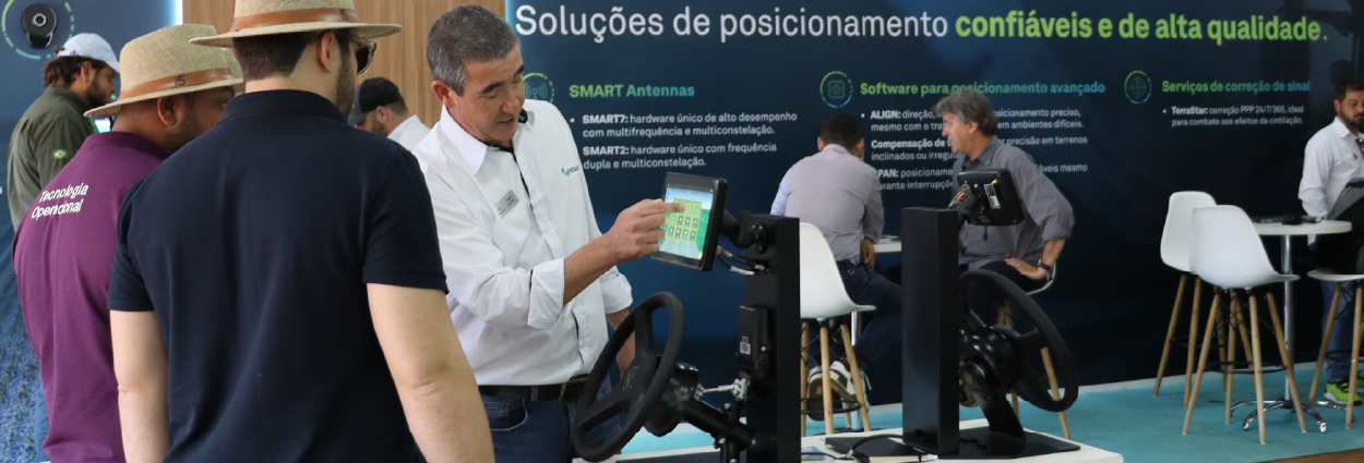 Scene at a trade show showing a man demonstrating a display unit