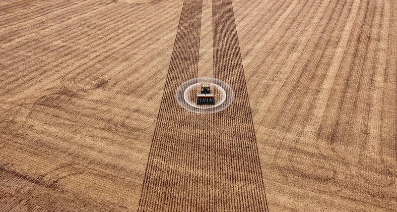 An agriculture vehicle in a field with graphics superimposed