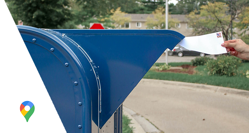 woman mailing a letter in US postal service drop box