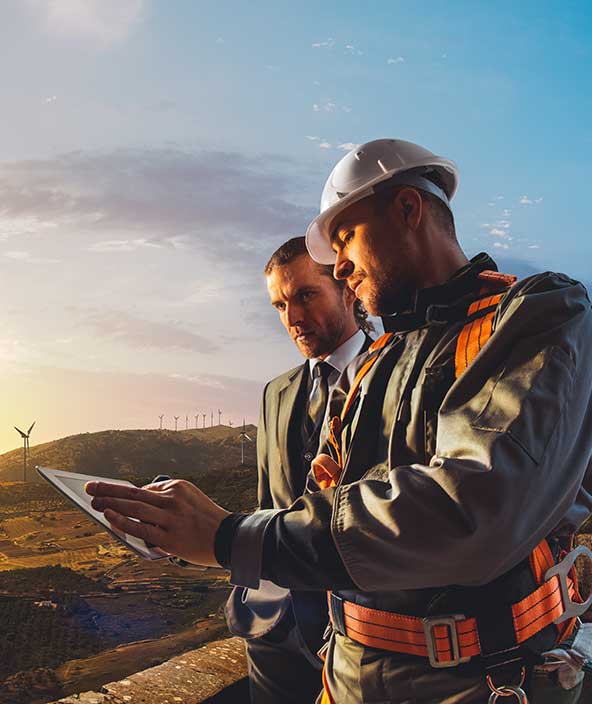 Operations manager and operator discuss the current operational status of a wind farm