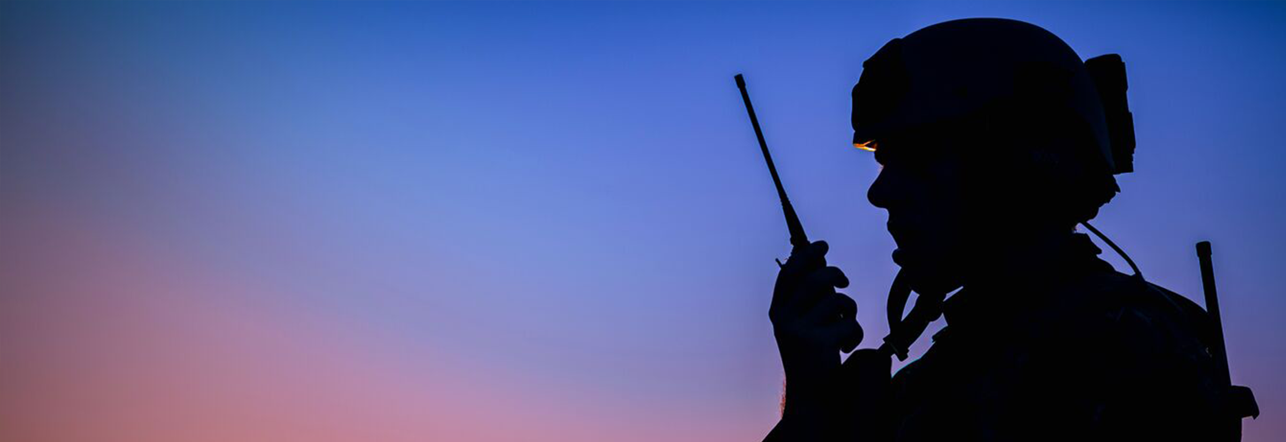 silhouette of soldier using radio