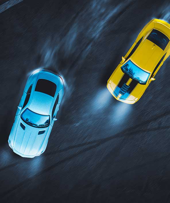 サーキットを駆け抜ける2台のレーシングカーの空撮画像
