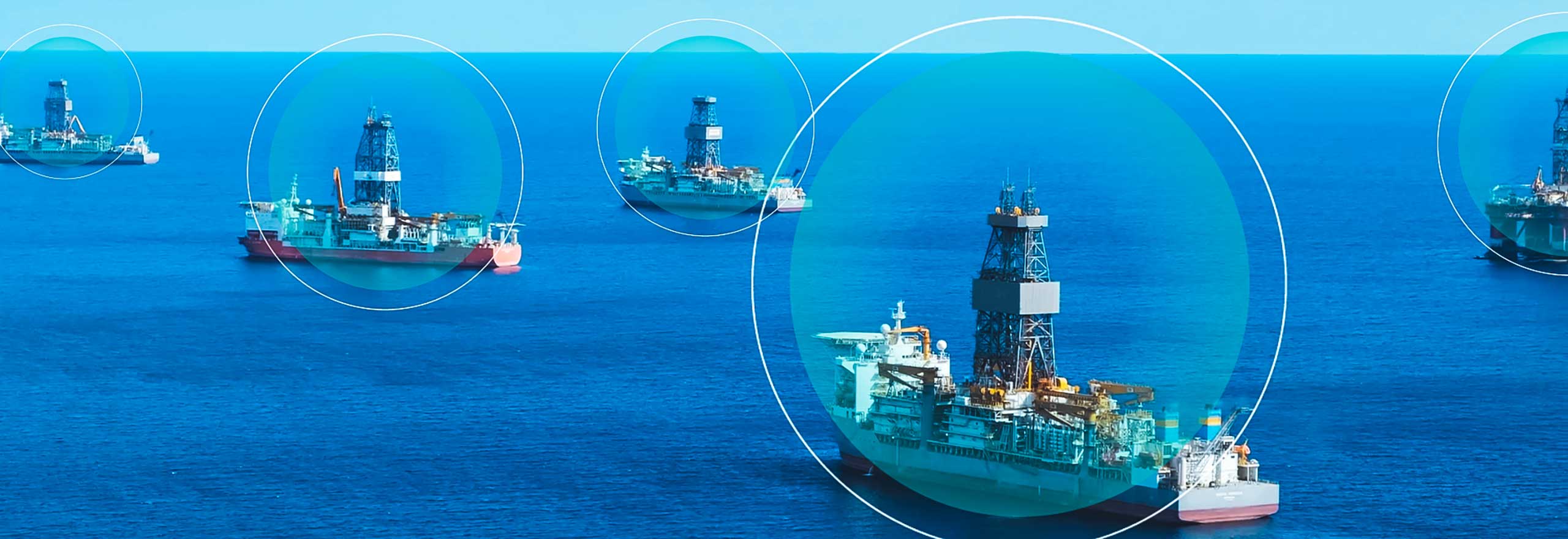 A series of dynamic positioning (DP) drilling vessels shown on a calm blue ocean