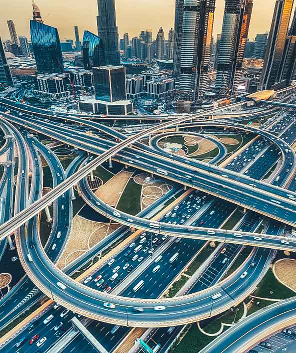 Aerial view of a big highway intersection in Dubai, UAE, at sunset.