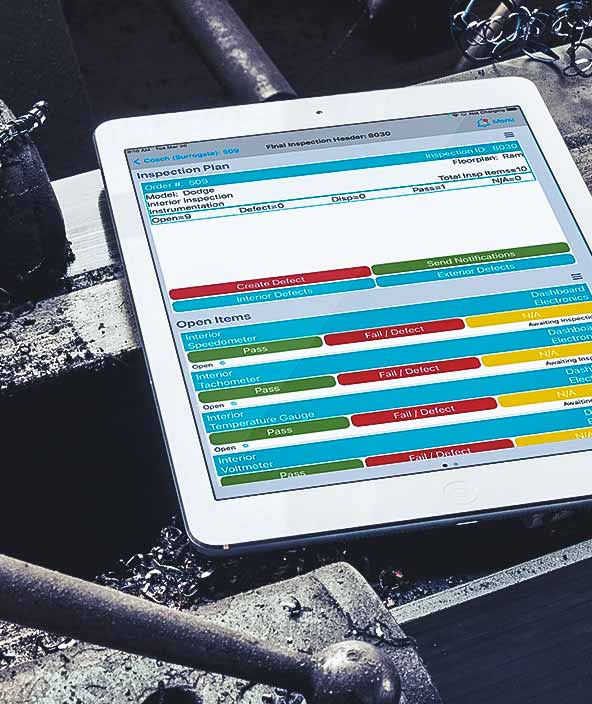 Tablet device displaying colourful dashboard in dark manufacturing environment