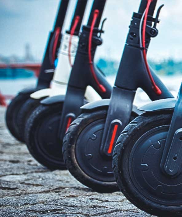 electric scooters parked and lined up in a row