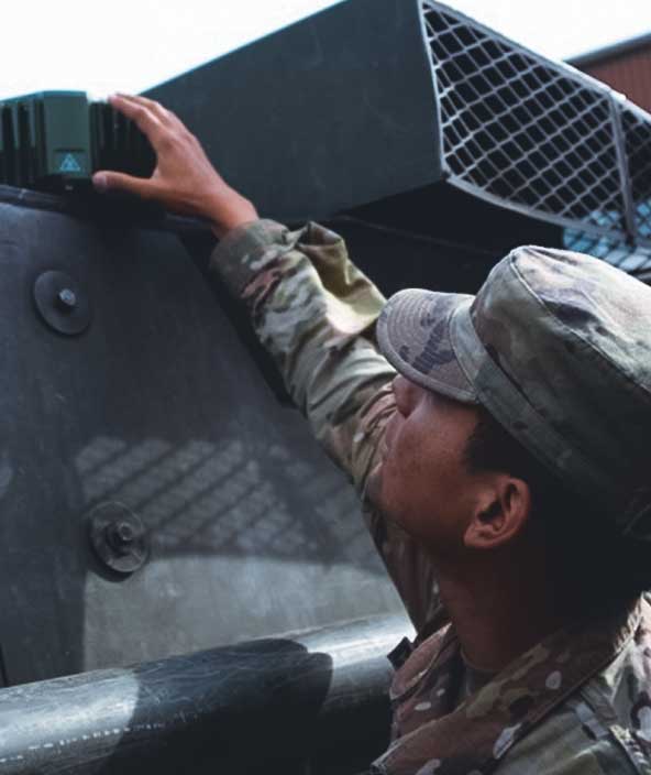 A soldier adjusts machinery