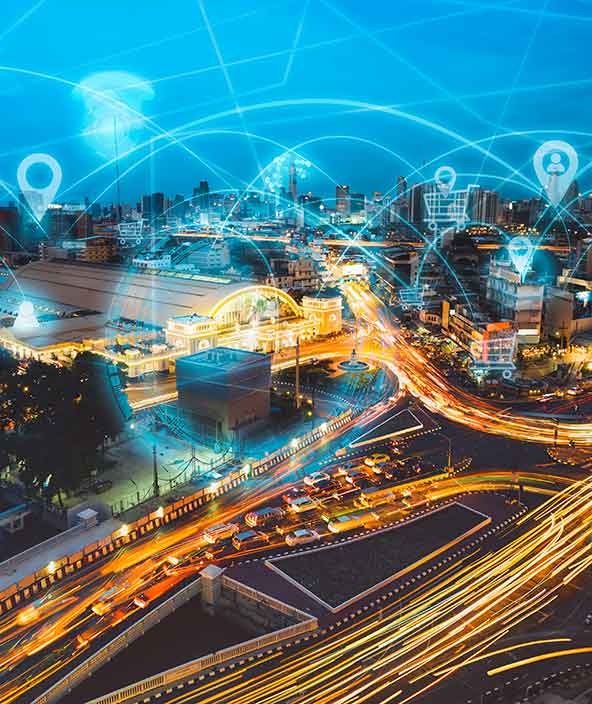 Image conceptuelle montrant le trafic dans un paysage urbain avec des véhicules connectés à l’IoT  