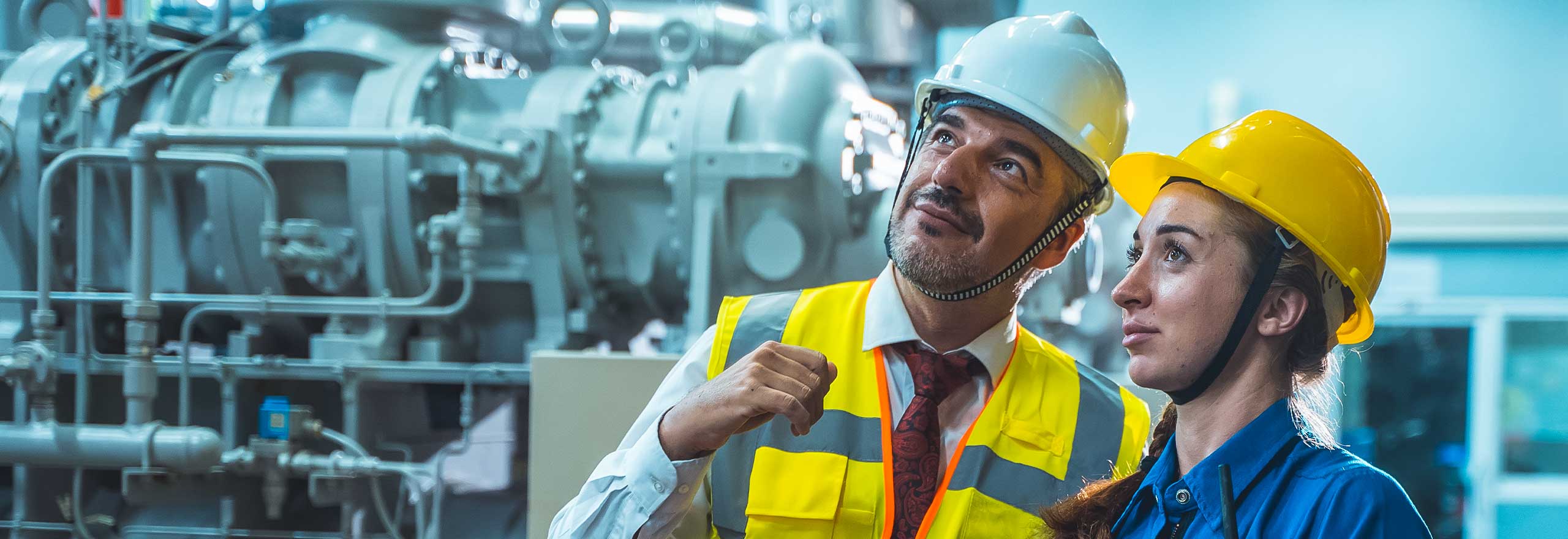 Operatori tecnici collegati che controllano e lavorano in una grande fabbrica industriale.