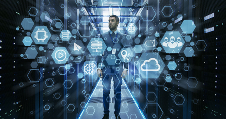 Man standing between vertical data banks with composite overlay depicting technical icons for digital transformation or manufacturing