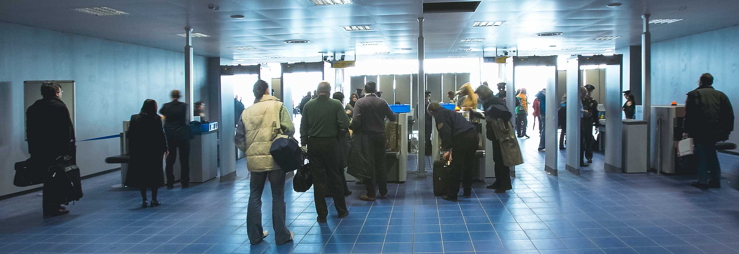 Passengers go through a security checkpoint 