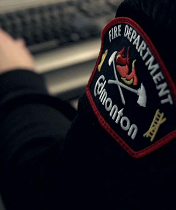 A closeup of the badge on the uniform of an Edmonton Fire Rescue Services member