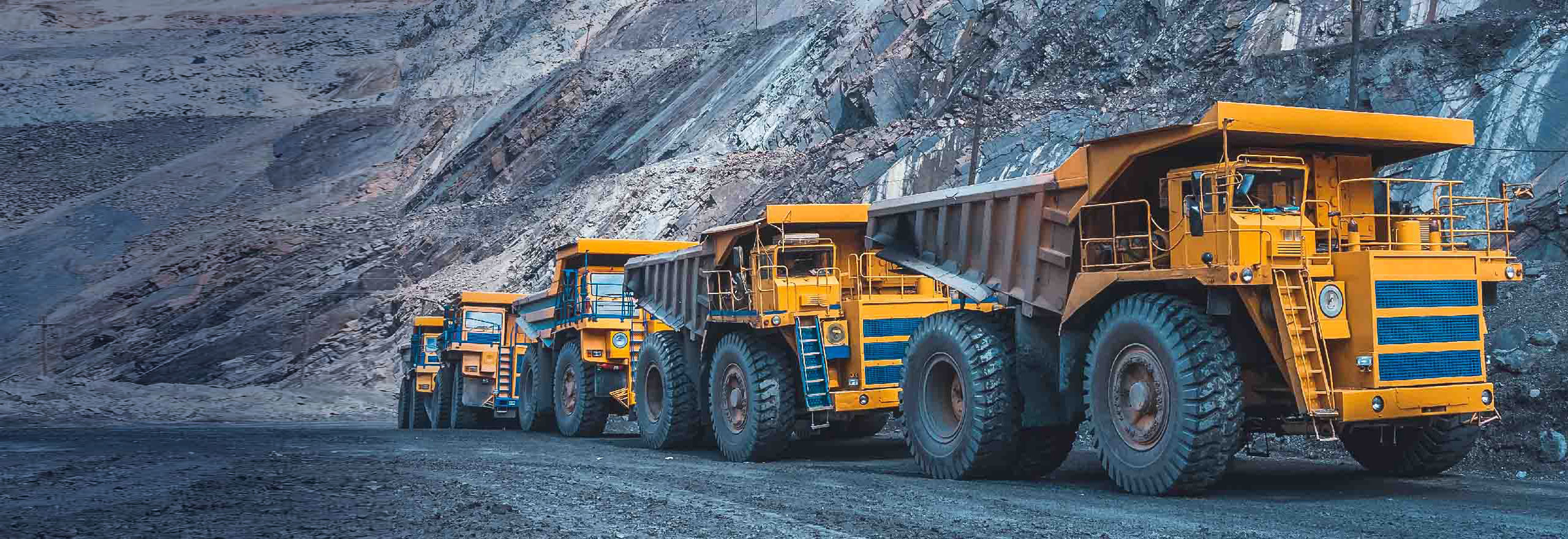 haul trucks driving on a mining road