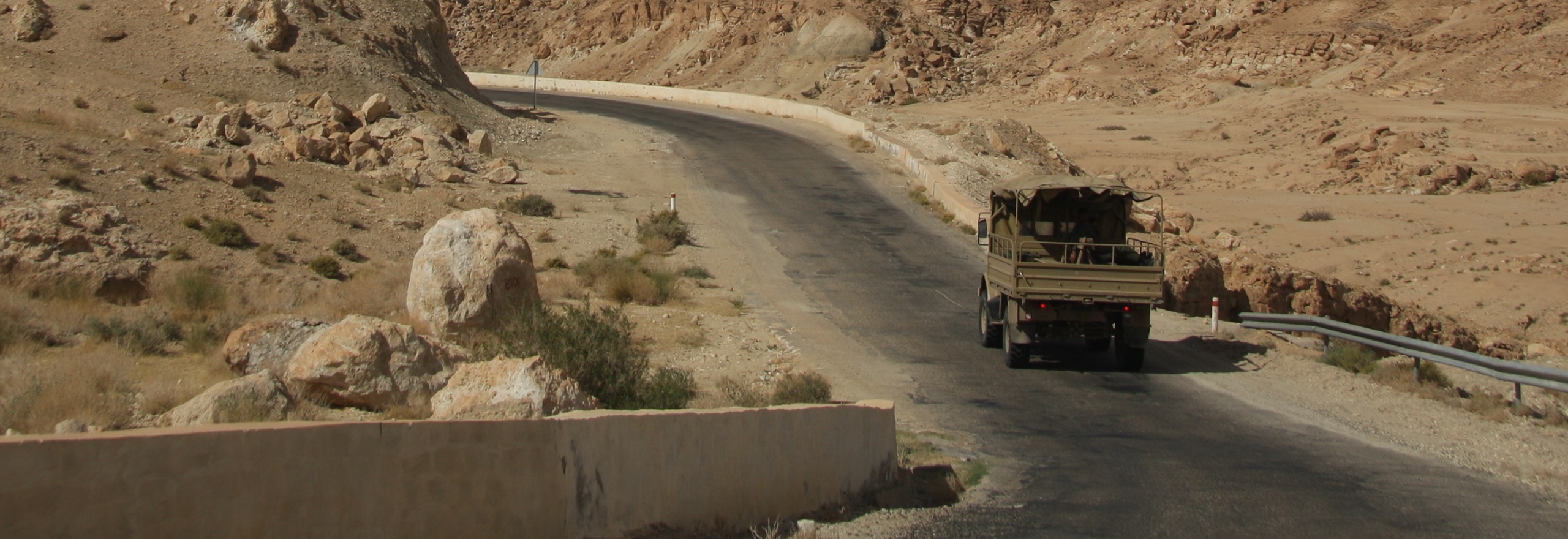 Military vehicle on desert road