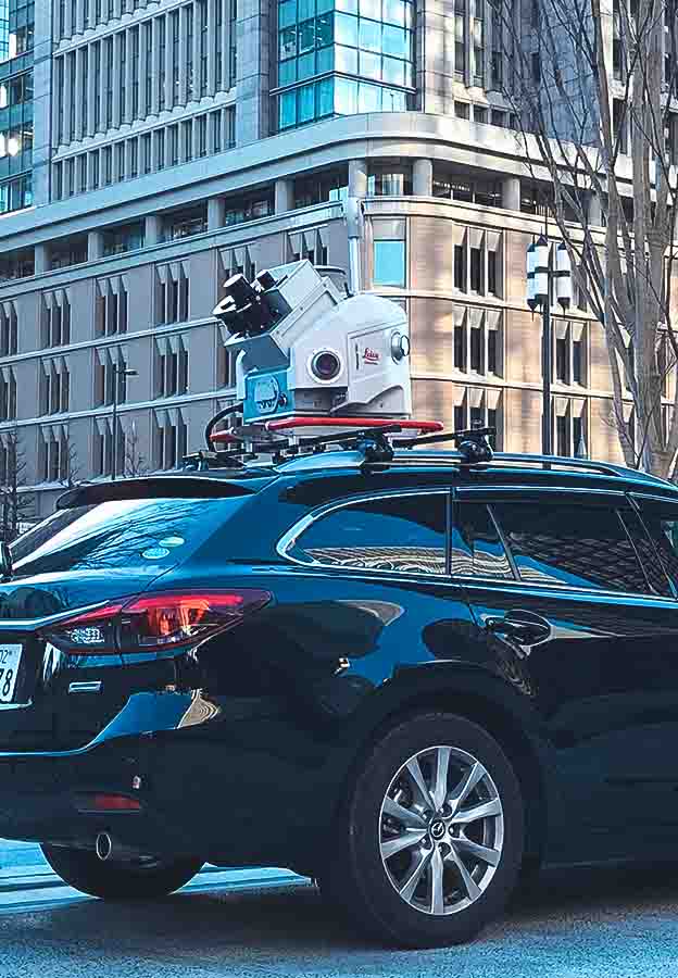 Land surveying technology on top of a passenger vehicle on the road