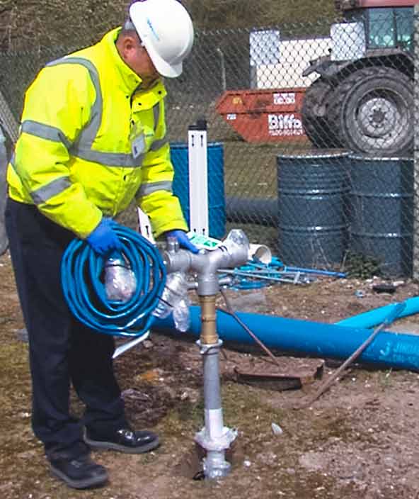 Anglian Water field worker setting up equipment