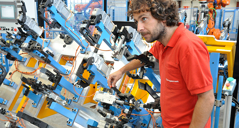 Image of a person adjusting a part on large piece of equipment