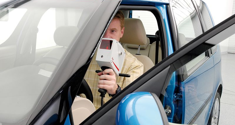 Image of person scanning a car interior from the drivers sear