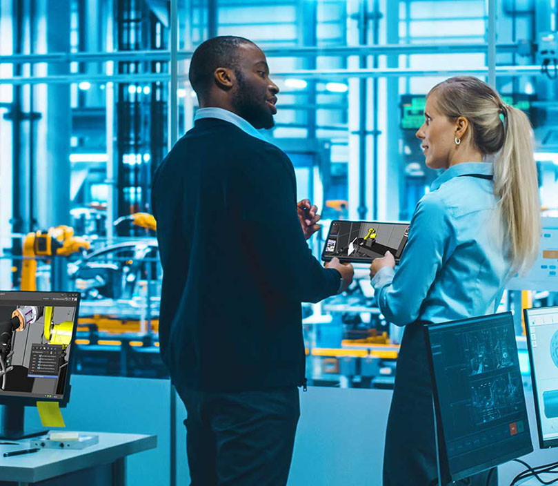 Colleagues collaborating over a tablet in an advanced manufacturing facility