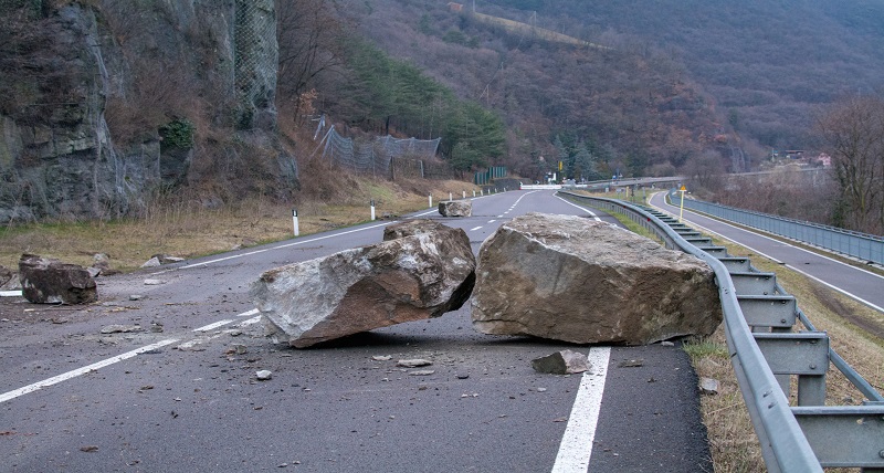Boulders from a landslide on highway.