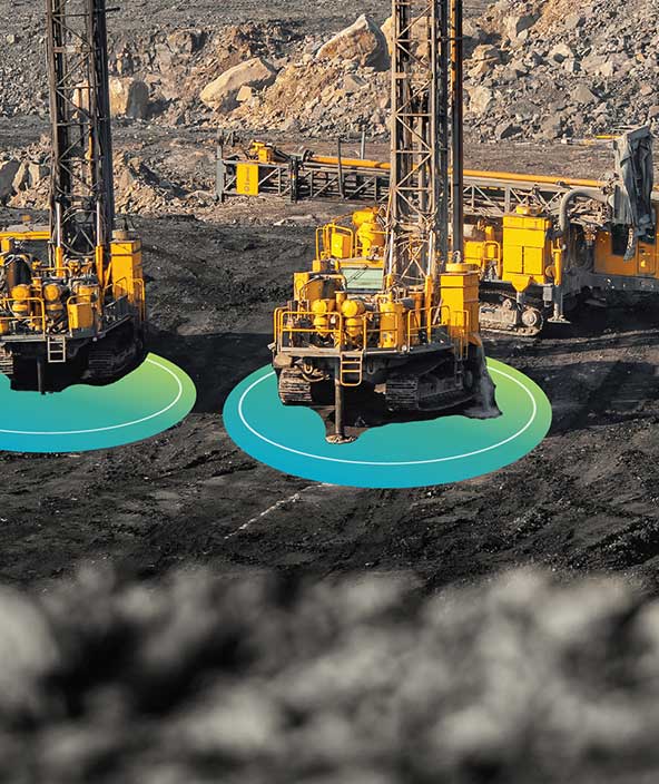 A mining field with digital overlays surrounding mining equipment to represent Smart Mining
