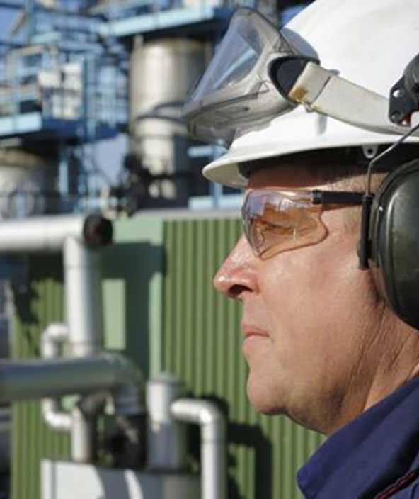 industrial facilities employee evaluating the plant
