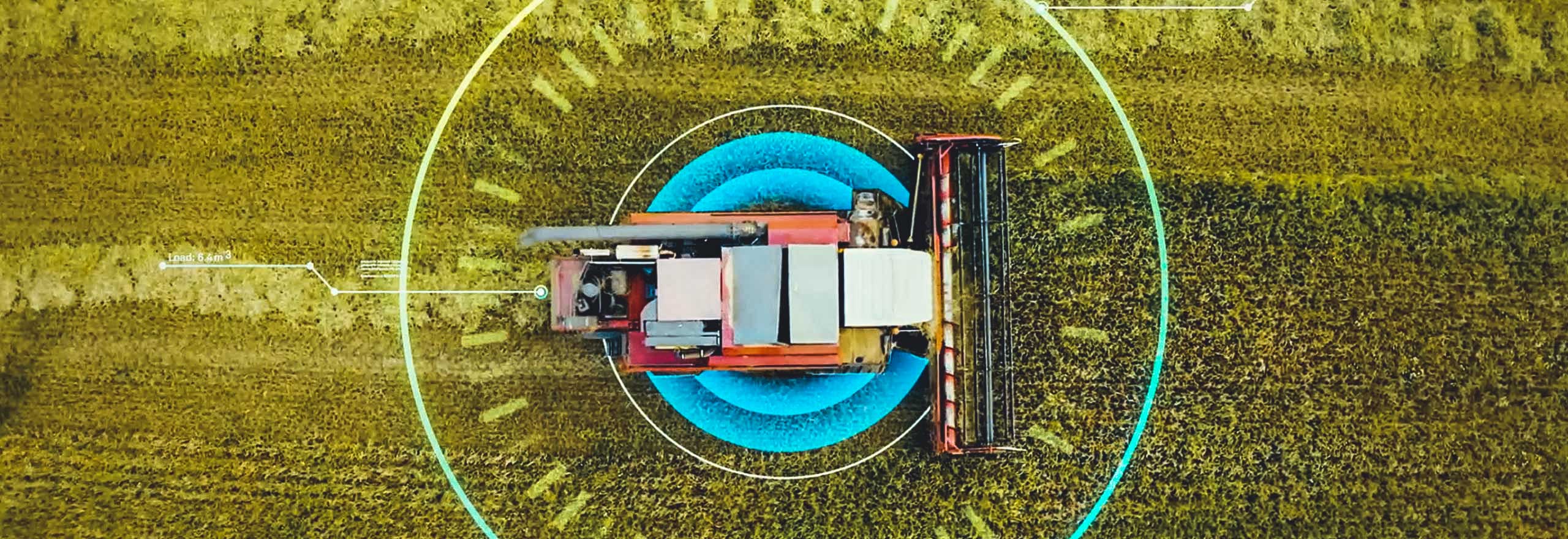 Uma imagem de um trator em um campo sobreposta com elementos digitais que representam a agricultura inteligente