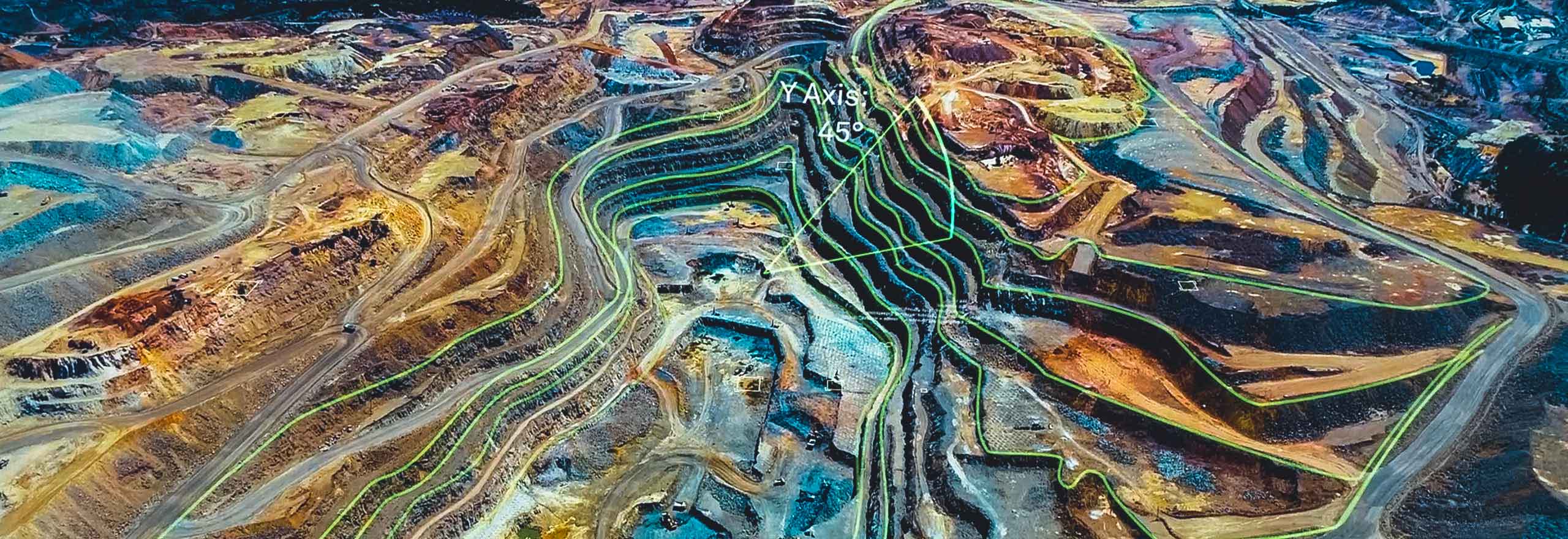 An aerial view of a mine overlayed with digital elements that represent analytics