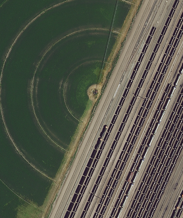 Aerial imagery of train tracks and farming circle