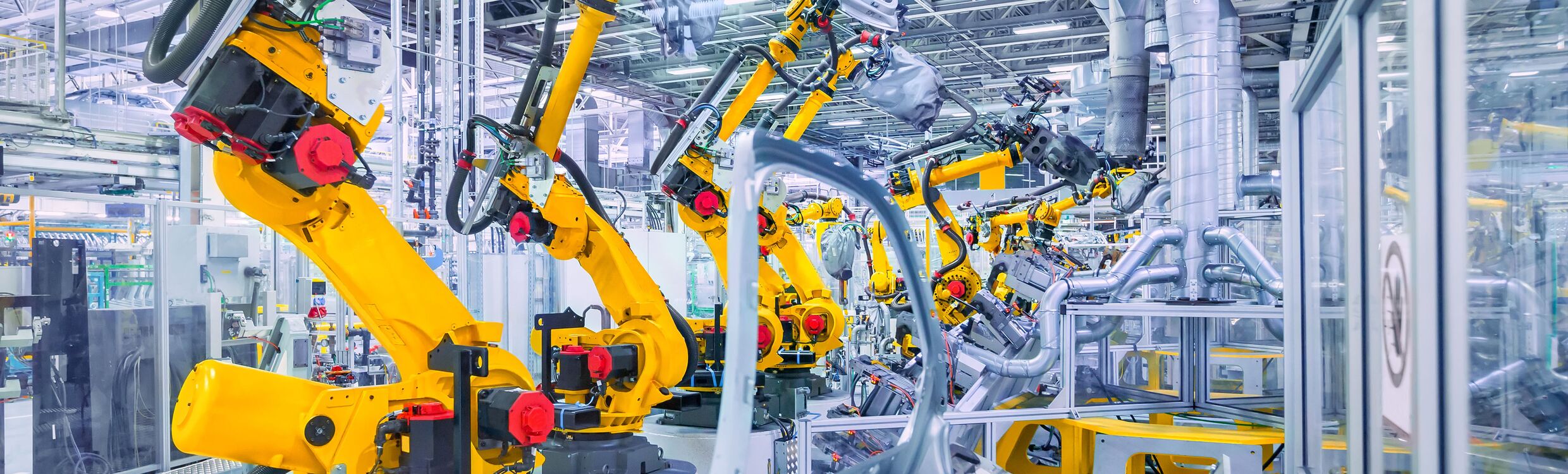 Manufacturing line full of robots on the line at a car manufacturing plant where a worker would conduct a line walk/smart audit. 