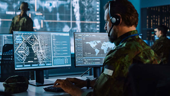 Soldier using computer in command center