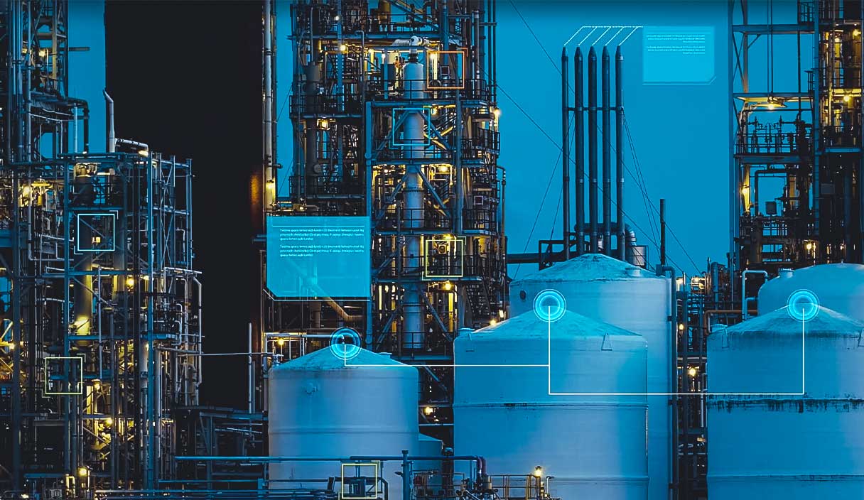 Nighttime image of an industrial facility overlaid with 'panes of glass' that depict interconnected data