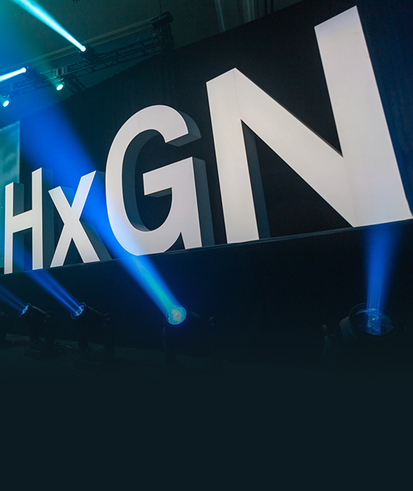 HxGN LIVE Global hero letters with coloured strobe lighting for dramatic effect