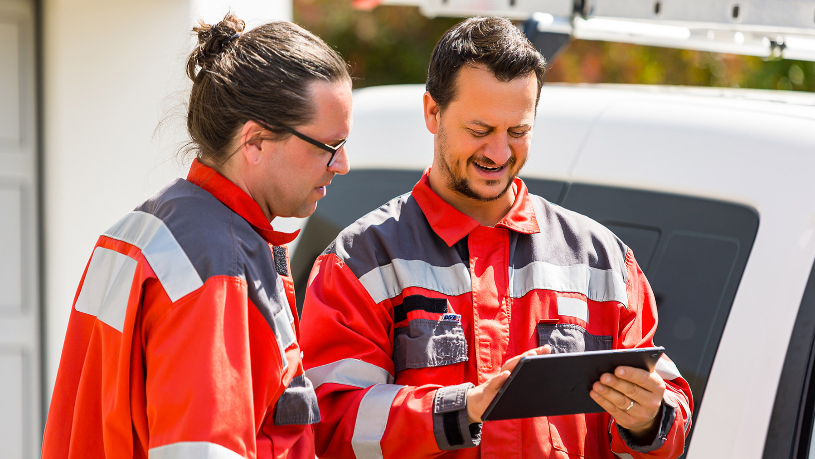 Two workers looking at tablet