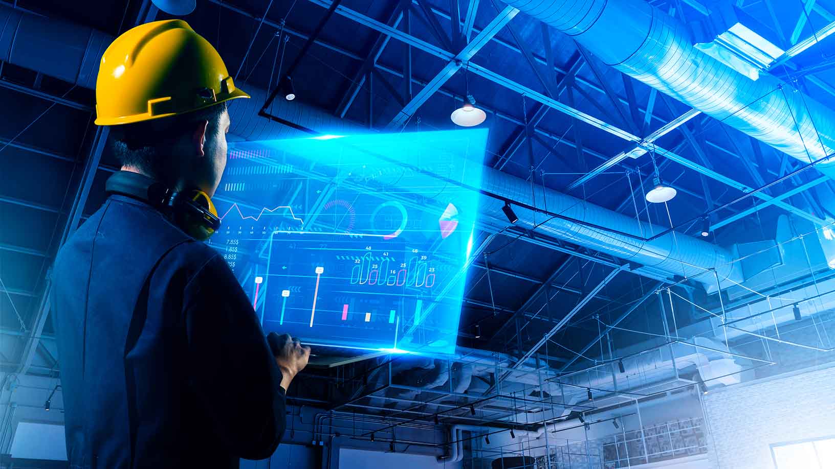 A manufacturing plant employee looks at a digitally enhanced analytics view