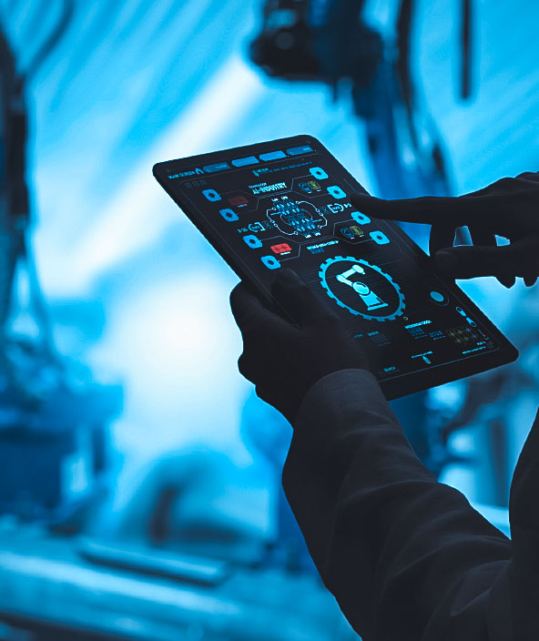 Industriemechanikerin, die mit Automatisierungsroboterarmen in einer intelligenten Fabrik mit Echtzeit-Überwachungssystemsoftware arbeitet.