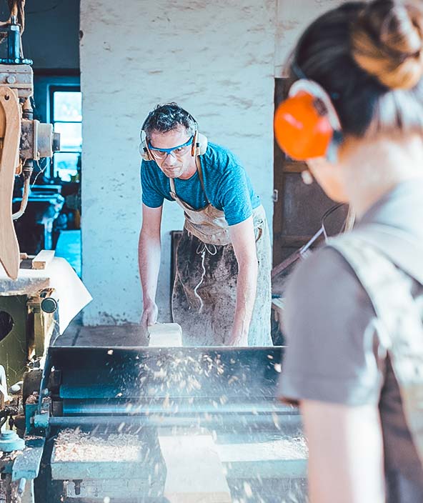 Schreiner hobeln Holz mit einer Maschine