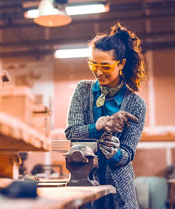 Woman working on clamp with protective glasses on
