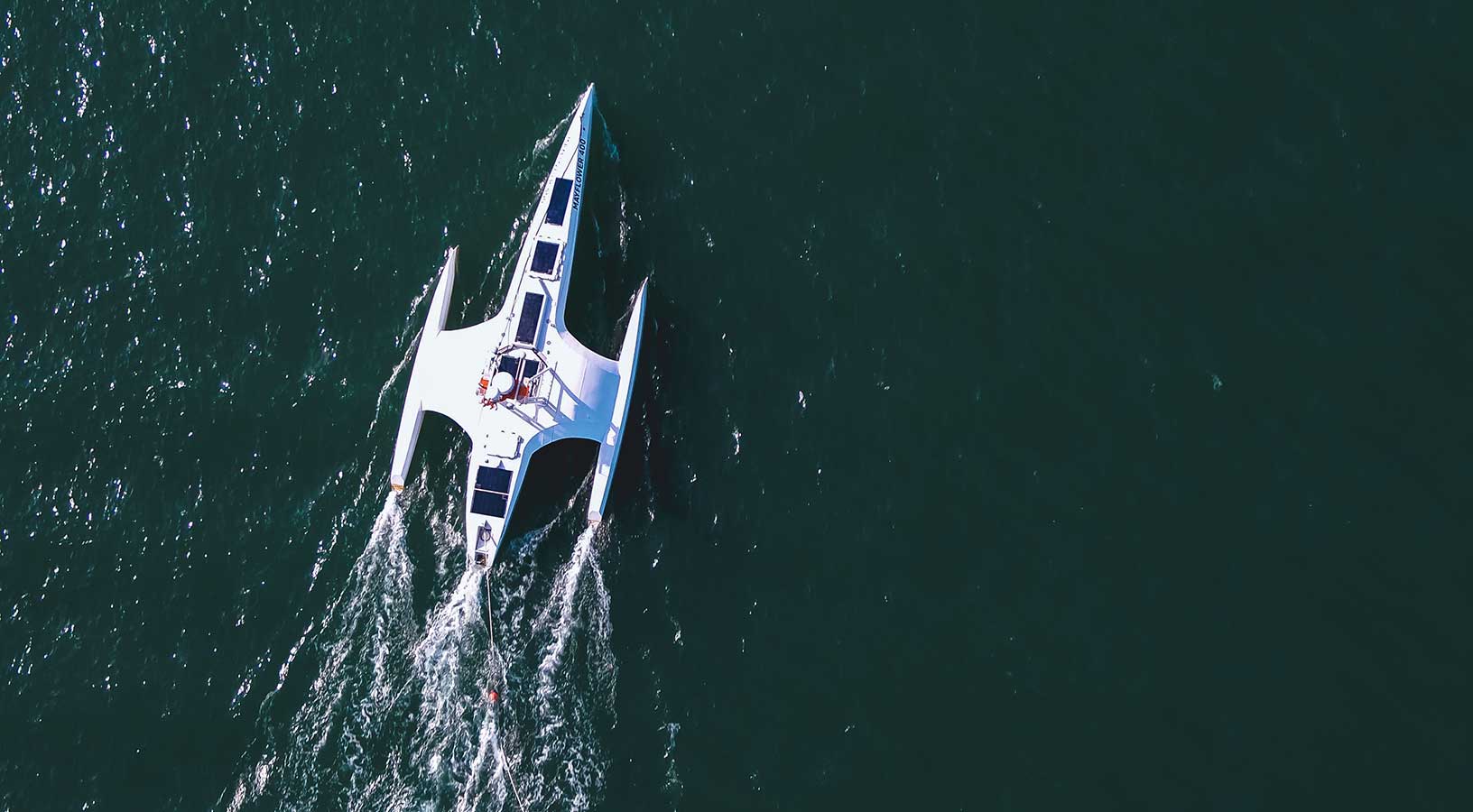 The Mayflower Autonomous Ship research vessel is shown from an aerial view during its sea trials.