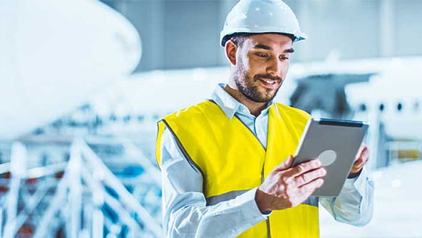 A technician reviews data on a tablet