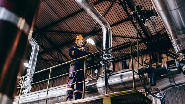 An engineer stood on a platform with a mobile device