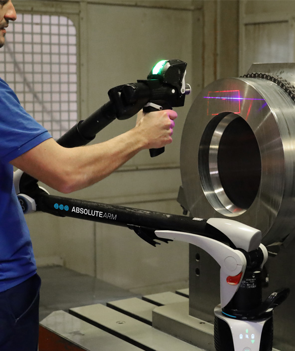 Portable measuring arm with a laser scanner attached inspecting a cylinder. 