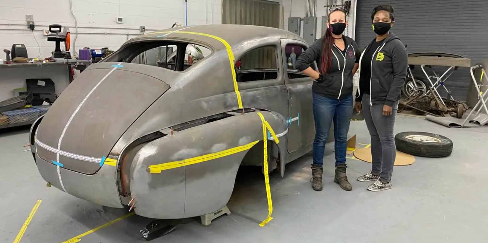 Portrait of Girl Gang Garage owners with custom car project