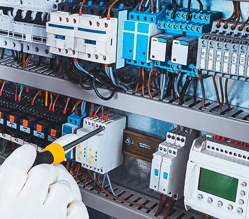 Image depicting hand of an engineer adjusting components in a technology rack