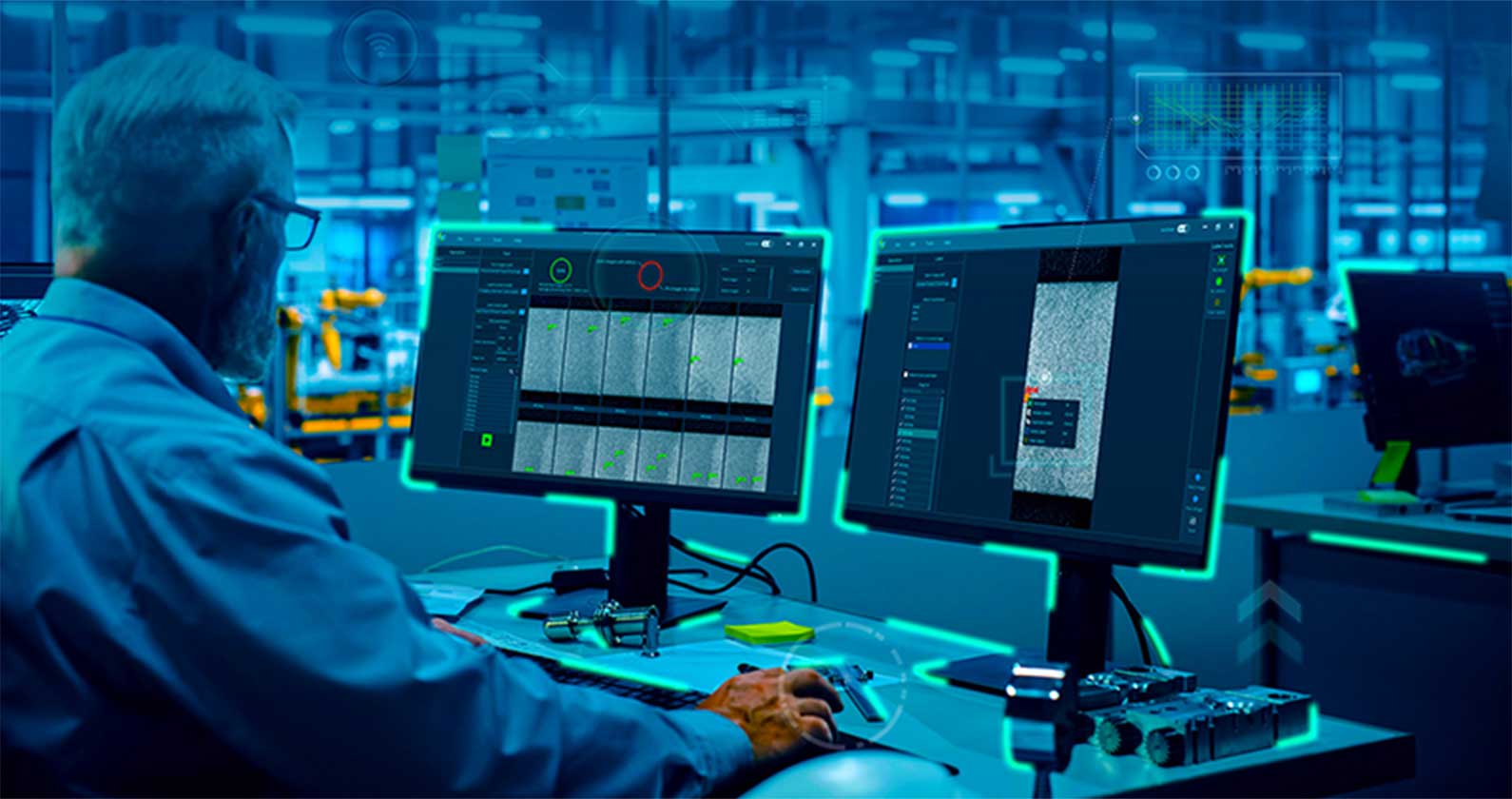 Over shoulder man using dual monitors viewing software