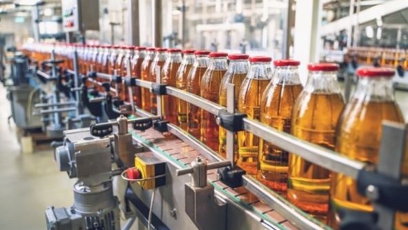Drinks bottles lined up on factory conveyor belt