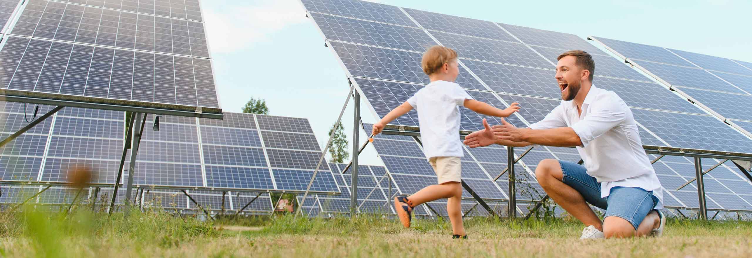 A child running to his father in a solar panel field