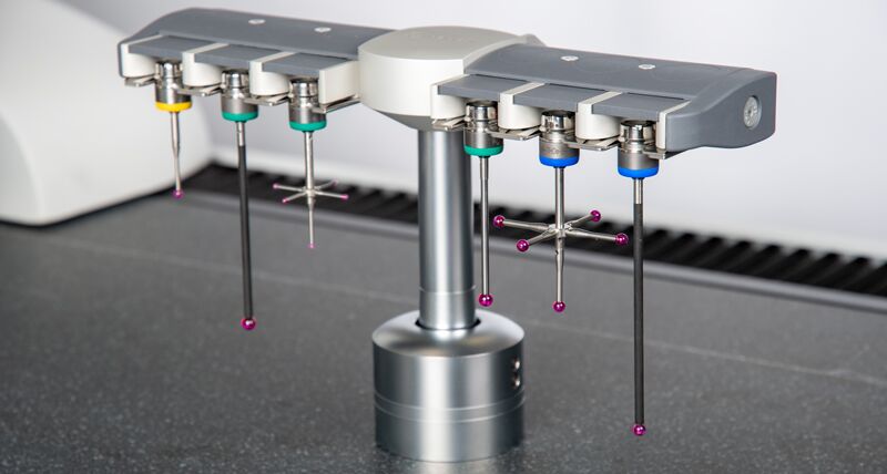 A probe rack holding 6 touch trigger probes. Each probe is of a different length. 